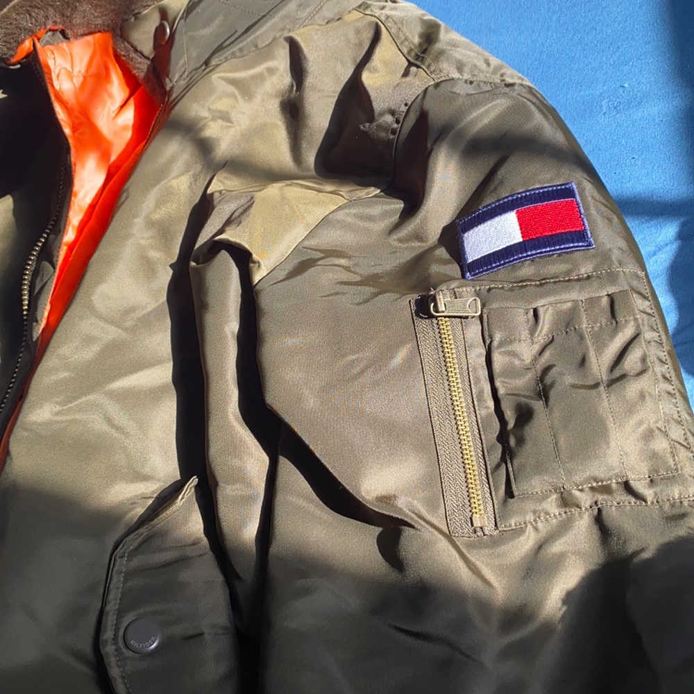 Olive Green jacket with orange interior. Detachable Fur on collar